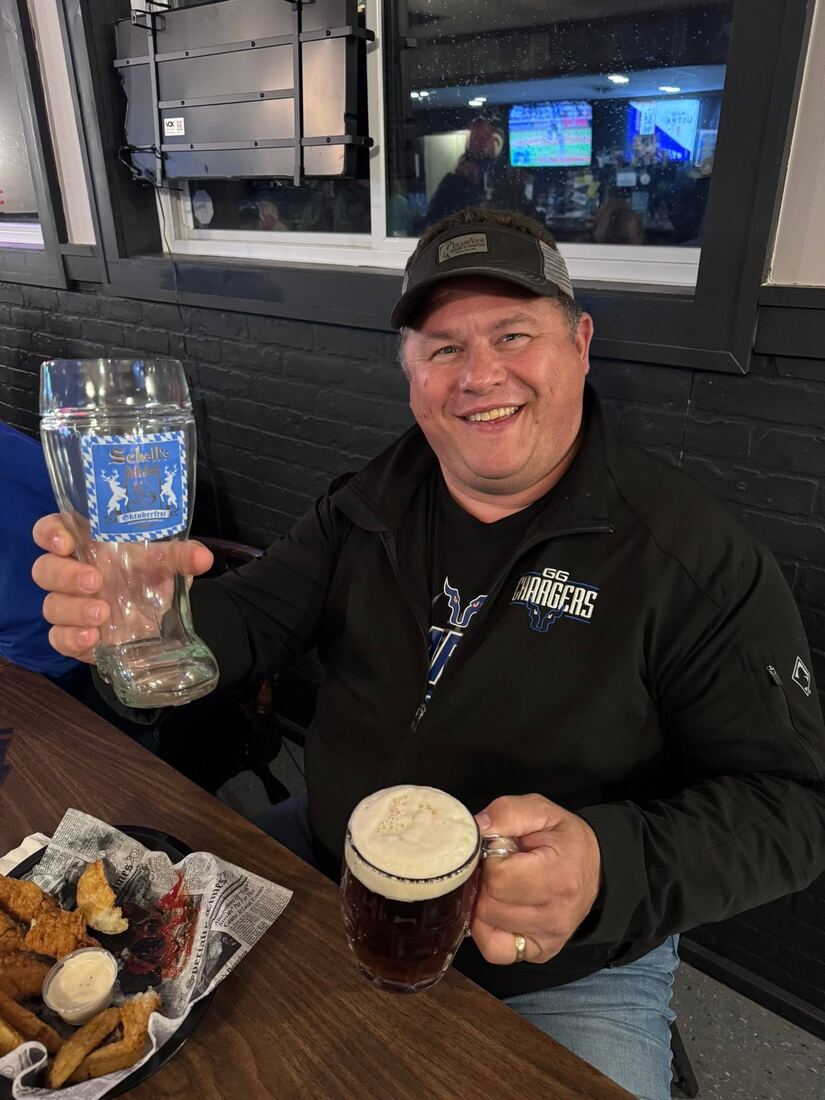 A regular raising a stein and a beer at The Hound